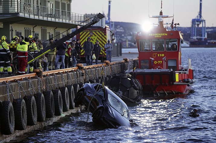 A car is retrieved from the water after driving out into the Osofjord, in Oslo, Norway, Thursday Feb. 1, 2024 (Hakon Mosvold Larsen/NTB Scanpix via AP)