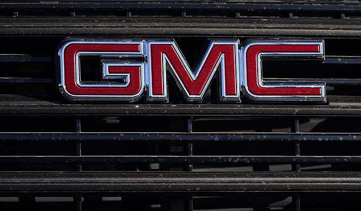 A GMC company logo is displayed at a GMC Truck dealership Sunday, Feb. 7, 2021, in Castle Rock, Colo.  General Motors is recalling more than 323,000 heavy-duty pickup trucks in the U.S., Tuesday, Feb. 6, 2024,  because the electronic tailgate release switches can short circuit and open the gates while the vehicles are in park.(AP Photo/David Zalubowski, File)