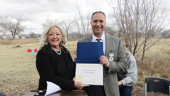 Penny Pew, district director for Rep. Gosar's office, gives congressional recognition certificate to Postmaster Anthony Golin. (Stan Bindell/For the Review)