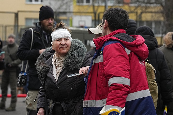 A medical worker helps a woman in a yard of an apartment building destroyed after Russian attack in Kyiv, Ukraine, Wednesday, Feb. 7, 2024. Authorities say Russia has fired cruise and ballistic missiles and Shahed-type drones at targets across Ukraine including the capital Kyiv. Officials said the Wednesday morning attack killed at least one civilian and injured 10 others. (Efrem Lukatsky/AP)