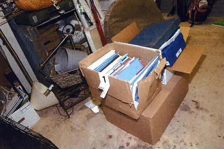 This image, contained in the report from special counsel Robert Hur, and marked with the number 1, shows a damaged box where classified documents were found in the garage of President Joe Biden in Wilmington, Del., during a search by the FBI on Dec. 21, 2022. (Justice Department via AP)