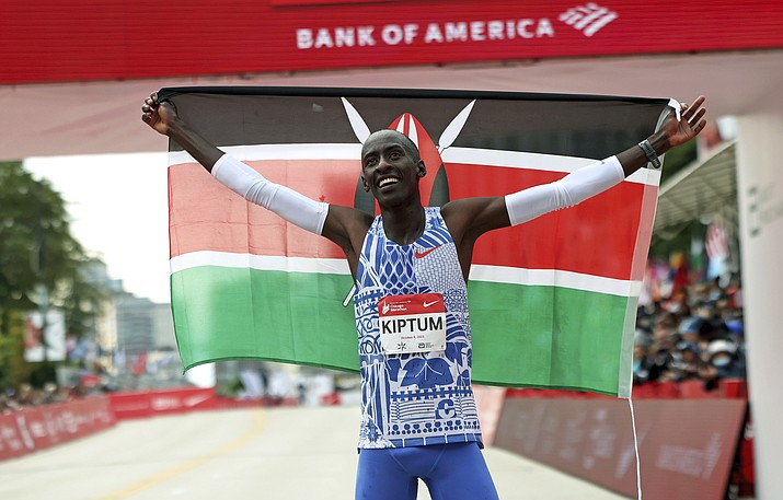 Kelvin Kiptum of Kenya celebrates his Chicago Marathon world record victory in Chicago's Grant Park on Sunday, Oct. 8, 2023. According to a fellow athlete, Kiptum died in a car crash in Kenya late Sunday, Feb. 11, 2024. He was 24. (Eileen T. Meslar/Chicago Tribune via AP)