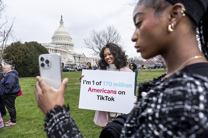Devotees of TikTok, Mona Swain, center, and her sister, Rachel Swain, right, both of Atlanta, pose with a sign at the Capitol in Washington, March 13, 2024. TikTok's extensive lobbying campaign is the latest tech industry push since the House passed legislation that would ban the popular app if its China-based owner doesn't sell its stake. TikTok has been urging its users to call their representatives. (J. Scott Applewhite/AP, File)